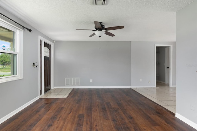 1806 11th St SW, Largo, FL 33778 - empty room featuring a ceiling fan, wood finished floors, and a textured ceiling