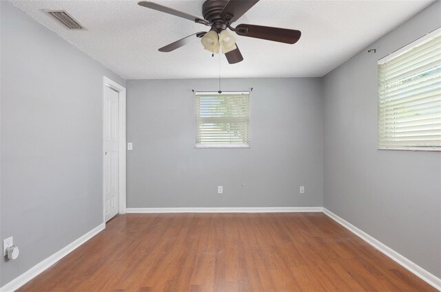 1806 11th St SW, Largo, FL 33778 - empty room with wood finished floors, a ceiling fan, and a textured ceiling