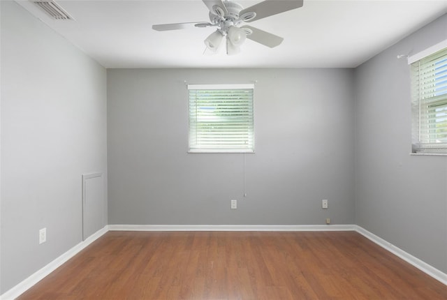 1806 11th St SW, Largo, FL 33778 - empty room with wood finished floors, healthy amount of natural light, and ceiling fan