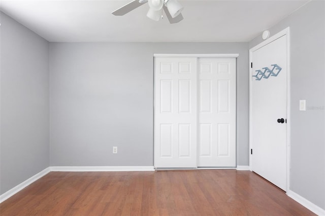 1806 11th St SW, Largo, FL 33778 - unfurnished bedroom featuring wood finished floors, a closet, and a ceiling fan