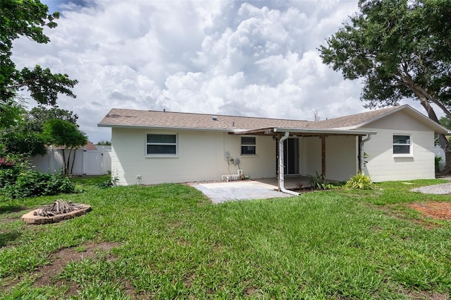 1806 11th St SW, Largo, FL 33778 - rear view of house featuring an outdoor fire pit and a patio