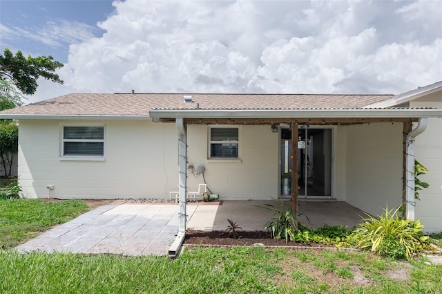 1806 11th St SW, Largo, FL 33778 - back of house featuring a patio and concrete block siding
