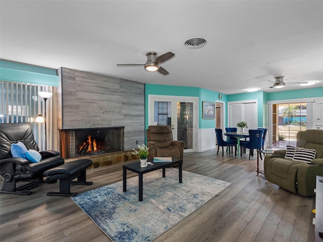 3944 49th Ave S, Saint Petersburg, FL 33711 - living room with ceiling fan, a tile fireplace, and wood finished floors