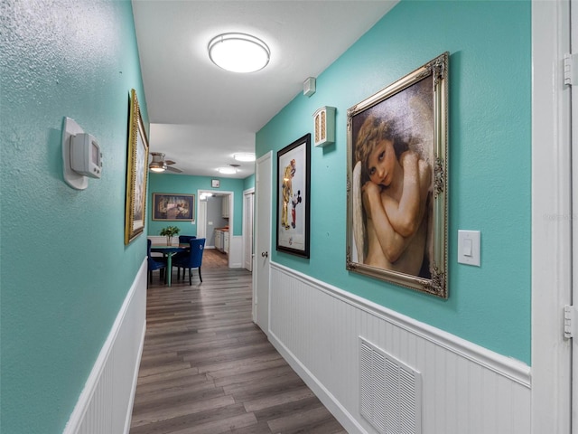 3944 49th Ave S, Saint Petersburg, FL 33711 - corridor featuring a wainscoted wall and wood finished floors