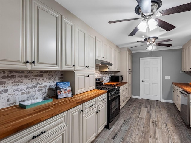 3944 49th Ave S, Saint Petersburg, FL 33711 - kitchen with butcher block counters, gas range, under cabinet range hood, black microwave, and ceiling fan