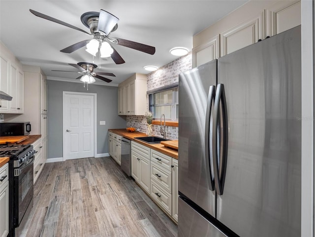 3944 49th Ave S, Saint Petersburg, FL 33711 - kitchen with appliances with stainless steel finishes, butcher block countertops, decorative backsplash, and a ceiling fan