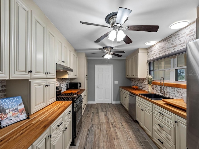 3944 49th Ave S, Saint Petersburg, FL 33711 - kitchen featuring butcher block countertops, gas range, under cabinet range hood, stainless steel dishwasher, and decorative backsplash