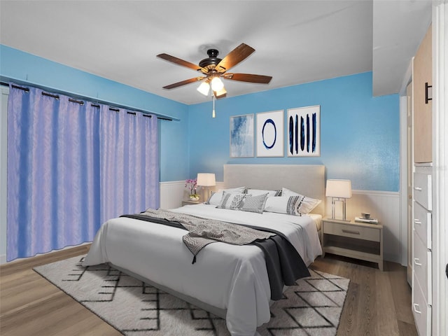 3944 49th Ave S, Saint Petersburg, FL 33711 - bedroom featuring wainscoting, wood finished floors, and a ceiling fan