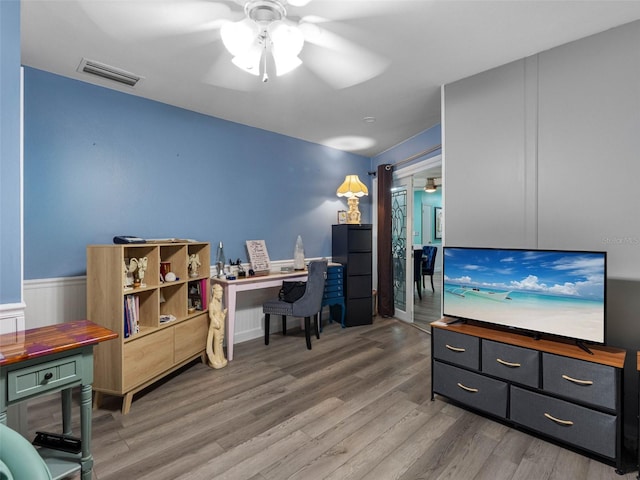 3944 49th Ave S, Saint Petersburg, FL 33711 - office area with ceiling fan, wood finished floors, and a wainscoted wall