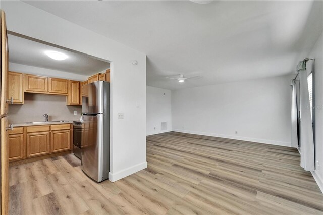 302 Andover Pl Unit G156, Sun City Center, FL 33573 - kitchen featuring freestanding refrigerator, light wood-style flooring, light countertops, and open floor plan