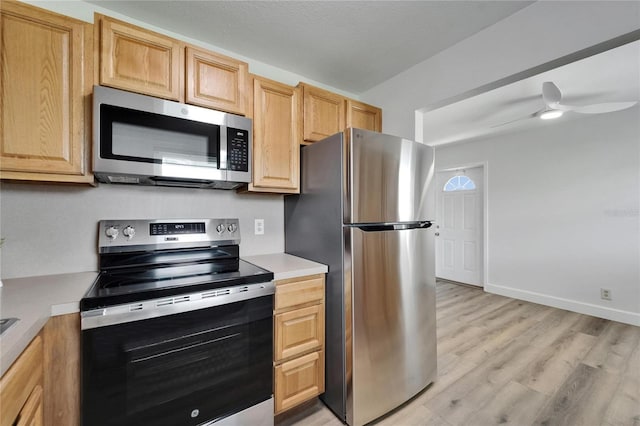 302 Andover Pl Unit G156, Sun City Center, FL 33573 - kitchen featuring appliances with stainless steel finishes, light countertops, light wood-style floors, and a ceiling fan