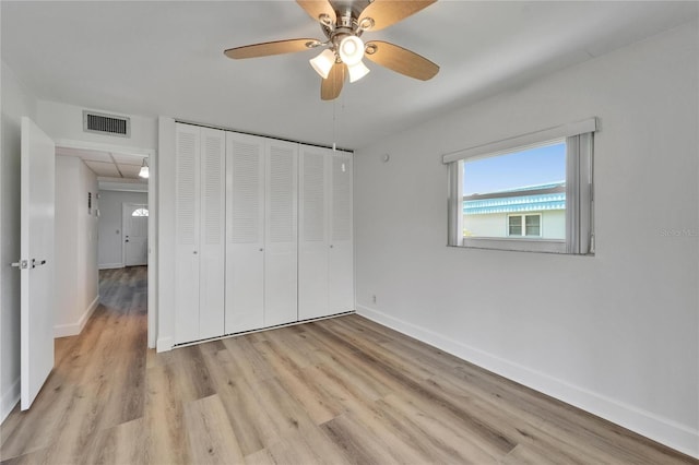 302 Andover Pl Unit G156, Sun City Center, FL 33573 - unfurnished bedroom with light wood-type flooring, a closet, and ceiling fan