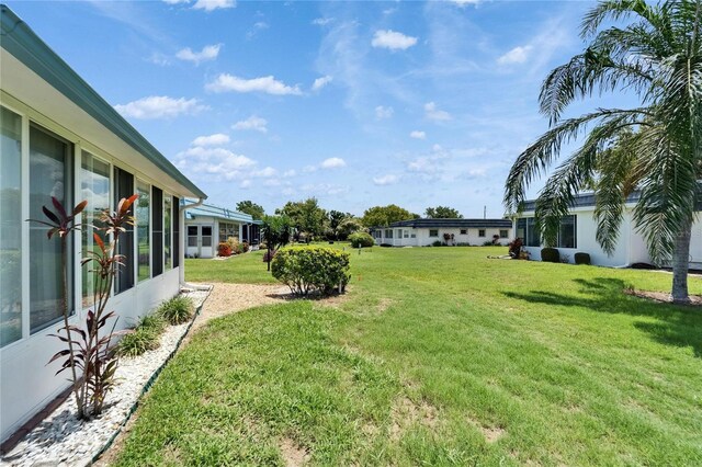302 Andover Pl Unit G156, Sun City Center, FL 33573 - view of grassy yard featuring a sunroom