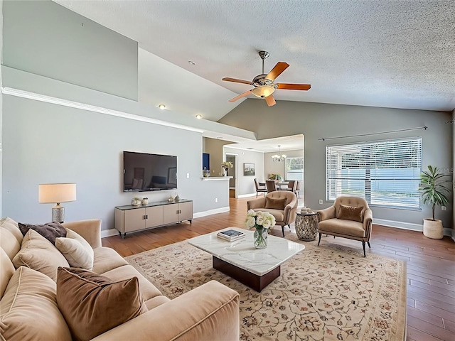 6001 Lemon Tree Ct, Tampa, FL 33625 - living room featuring wood-type flooring, a ceiling fan, lofted ceiling, a textured ceiling, and a chandelier