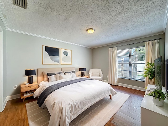6001 Lemon Tree Ct, Tampa, FL 33625 - bedroom featuring ornamental molding, a textured ceiling, and wood finished floors