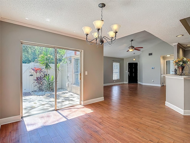 6001 Lemon Tree Ct, Tampa, FL 33625 - unfurnished dining area featuring ceiling fan, a textured ceiling, a chandelier, light wood-style floors, and lofted ceiling
