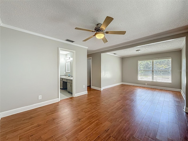 6001 Lemon Tree Ct, Tampa, FL 33625 - spare room featuring a ceiling fan, dark wood-style floors, a textured ceiling, and crown molding