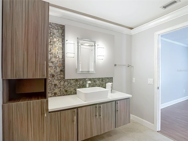 6001 Lemon Tree Ct, Tampa, FL 33625 - bathroom featuring backsplash, vanity, and crown molding