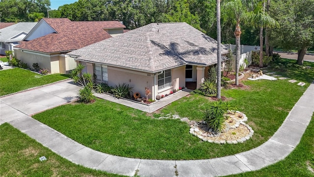 6001 Lemon Tree Ct, Tampa, FL 33625 - view of front of home featuring roof with shingles, stucco siding, a front lawn, driveway, and a garage