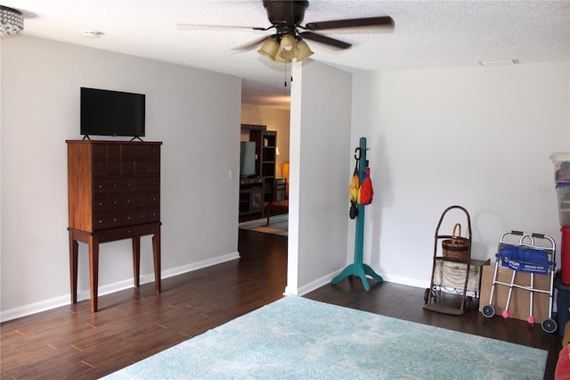 2101 Sunset Point Rd Unit 2304, Clearwater, FL 33765 - bedroom with wood finished floors, a textured ceiling, and a ceiling fan