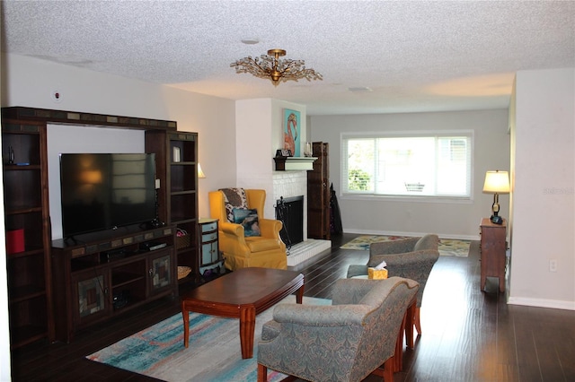 2101 Sunset Point Rd Unit 2304, Clearwater, FL 33765 - living room with a textured ceiling, wood finished floors, a fireplace, and a chandelier