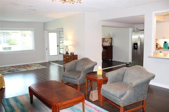 2101 Sunset Point Rd Unit 2304, Clearwater, FL 33765 - living area featuring wood finished floors and a textured ceiling