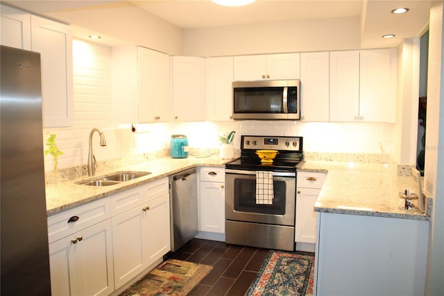 2101 Sunset Point Rd Unit 2304, Clearwater, FL 33765 - kitchen featuring appliances with stainless steel finishes, backsplash, recessed lighting, light stone counters, and white cabinets