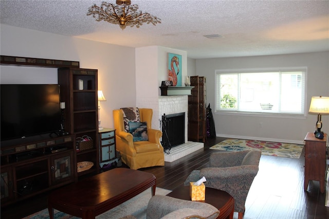 2101 Sunset Point Rd Unit 2304, Clearwater, FL 33765 - living area with a fireplace, a textured ceiling, wood finished floors, and a chandelier