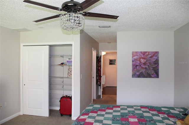 2101 Sunset Point Rd Unit 2304, Clearwater, FL 33765 - carpeted bedroom featuring a textured ceiling, a closet, and ceiling fan