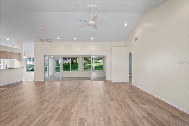 11412 Alden Ct, Hudson, FL 34667 - unfurnished living room featuring ceiling fan, high vaulted ceiling, light wood-type flooring, and recessed lighting
