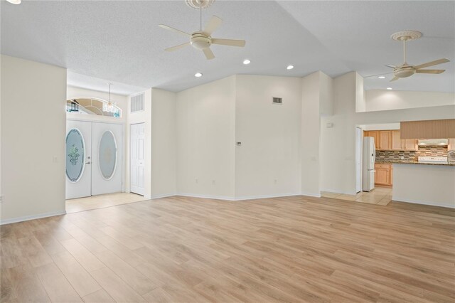 11412 Alden Ct, Hudson, FL 34667 - unfurnished living room with ceiling fan, light wood-style floors, high vaulted ceiling, and recessed lighting