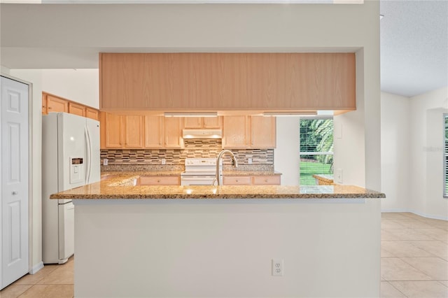 11412 Alden Ct, Hudson, FL 34667 - kitchen with light tile patterned floors, light brown cabinets, white appliances, backsplash, and under cabinet range hood