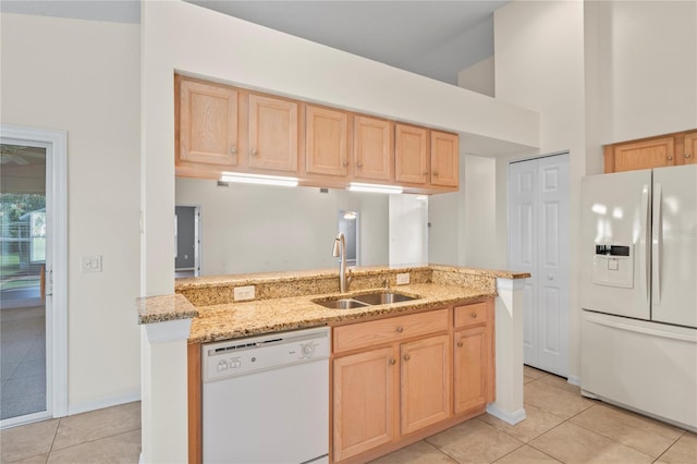 11412 Alden Ct, Hudson, FL 34667 - kitchen with white appliances, light brown cabinetry, light tile patterned floors, and light stone countertops