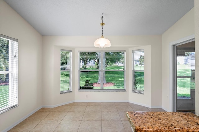 11412 Alden Ct, Hudson, FL 34667 - unfurnished dining area with light tile patterned floors and a textured ceiling