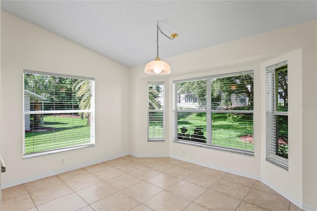11412 Alden Ct, Hudson, FL 34667 - unfurnished dining area featuring a textured ceiling, light tile patterned floors, and vaulted ceiling