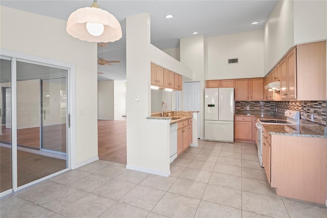 11412 Alden Ct, Hudson, FL 34667 - kitchen featuring white appliances, a high ceiling, light tile patterned floors, tasteful backsplash, and a ceiling fan