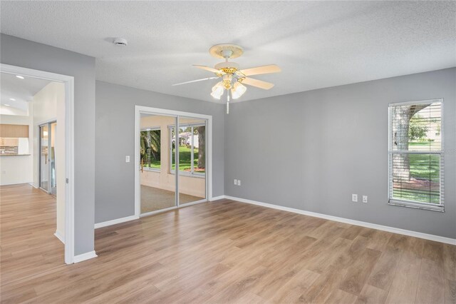 11412 Alden Ct, Hudson, FL 34667 - empty room featuring light wood-style flooring, a ceiling fan, and a textured ceiling