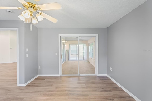 11412 Alden Ct, Hudson, FL 34667 - empty room with a ceiling fan, light wood-style floors, a smoke detector, and a textured ceiling