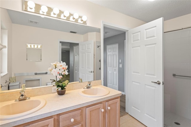11412 Alden Ct, Hudson, FL 34667 - bathroom featuring double vanity, a tile shower, and tile patterned floors