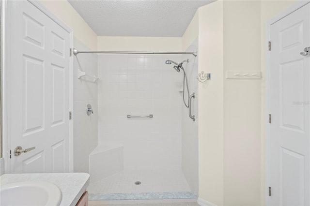 11412 Alden Ct, Hudson, FL 34667 - full bathroom featuring vanity, a tile shower, and a textured ceiling