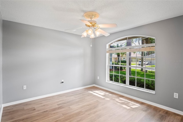 11412 Alden Ct, Hudson, FL 34667 - unfurnished room featuring plenty of natural light, wood finished floors, a textured ceiling, and a ceiling fan