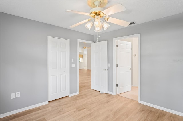 11412 Alden Ct, Hudson, FL 34667 - unfurnished bedroom featuring light wood finished floors, a closet, and a ceiling fan