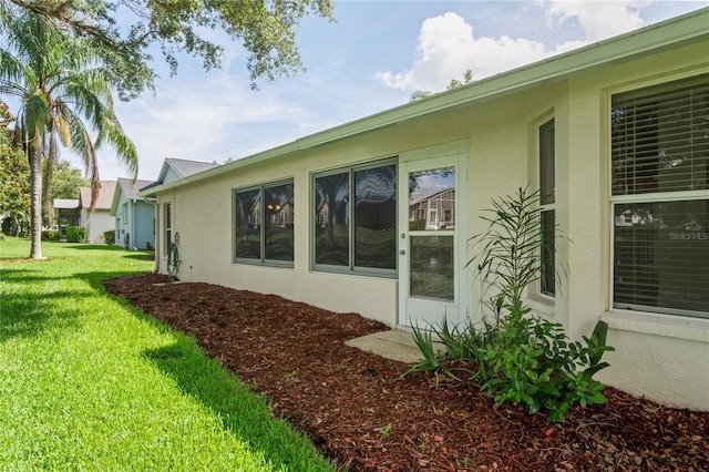 11412 Alden Ct, Hudson, FL 34667 - view of property exterior featuring stucco siding and a yard