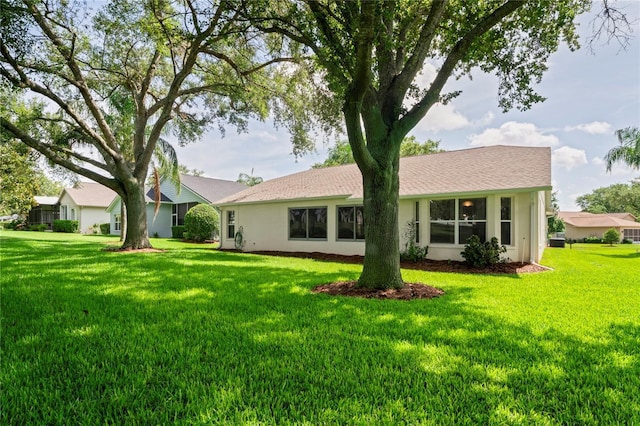 11412 Alden Ct, Hudson, FL 34667 - rear view of property featuring a yard and stucco siding