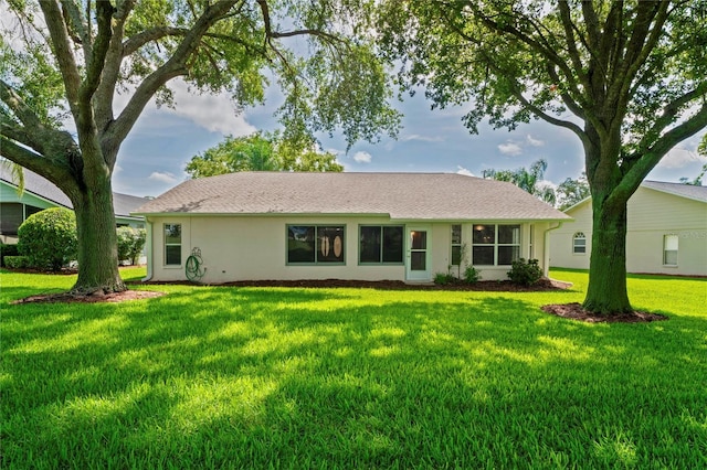 11412 Alden Ct, Hudson, FL 34667 - back of house featuring a yard and stucco siding
