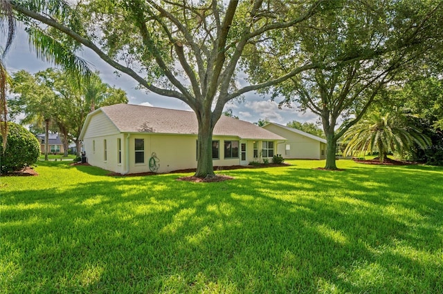 11412 Alden Ct, Hudson, FL 34667 - back of house with a lawn and stucco siding