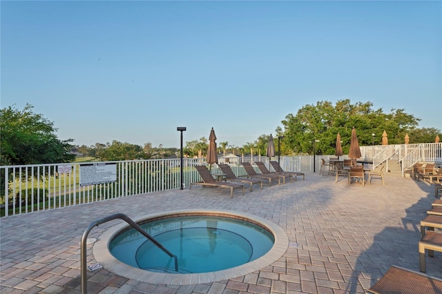11412 Alden Ct, Hudson, FL 34667 - view of pool featuring a community hot tub and a patio