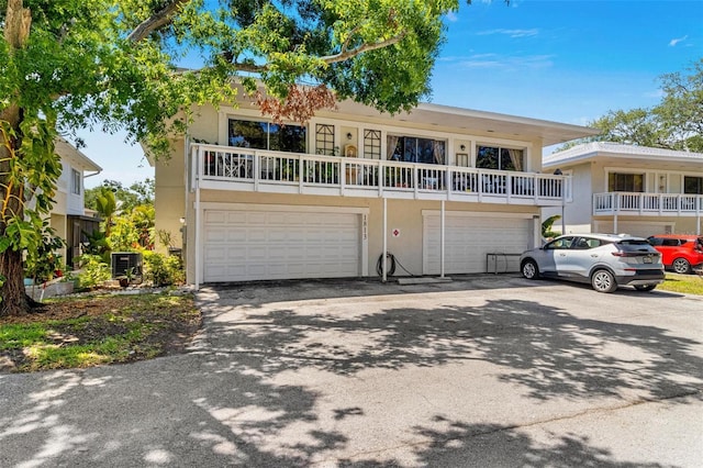 1813 Bough Ave Unit B, Clearwater, FL 33760 - view of front of house with an attached garage, stucco siding, and driveway