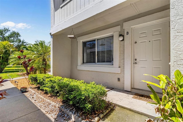 1813 Bough Ave Unit B, Clearwater, FL 33760 - doorway to property featuring stucco siding