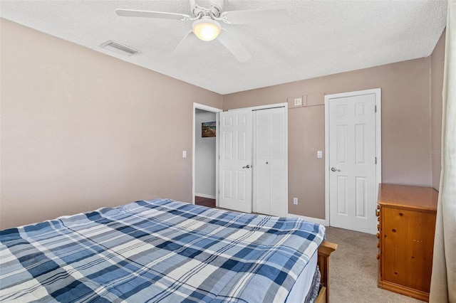 1813 Bough Ave Unit B, Clearwater, FL 33760 - bedroom with a textured ceiling, a closet, ceiling fan, and light carpet